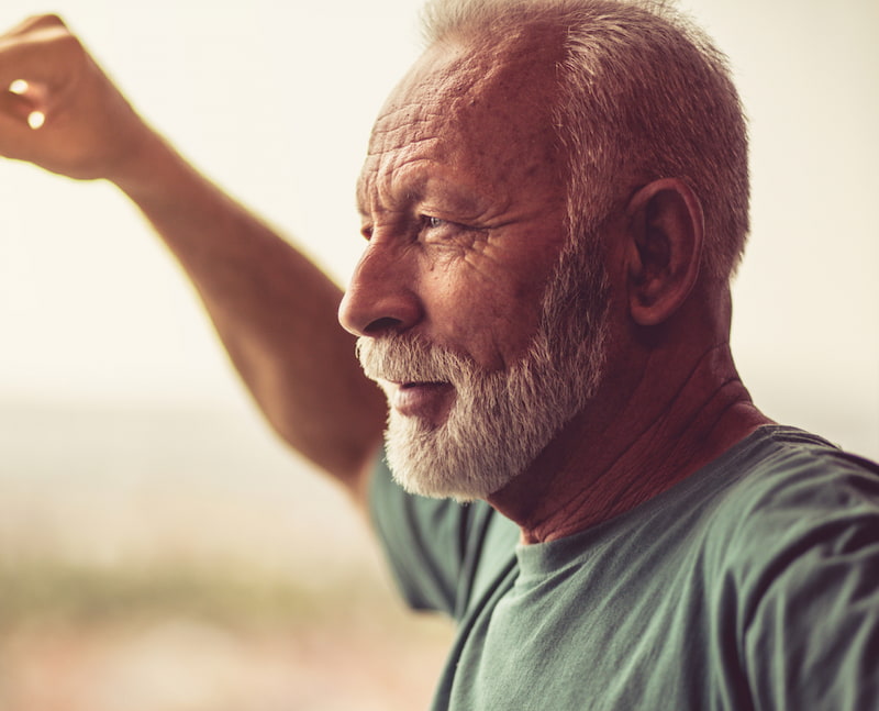 Man looking out window